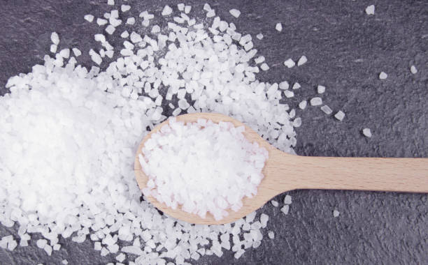 istock Coarse sea salt on dark background. Top view. 944317618