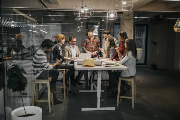 Group of architects talking while having a meeting at casual office.