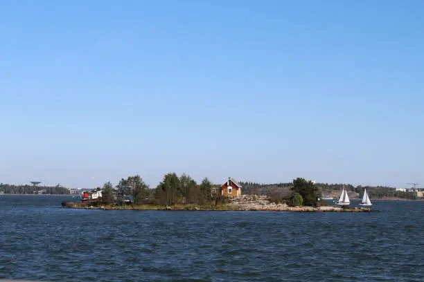 Small island with a small house off the coast of Helsinki, Finland