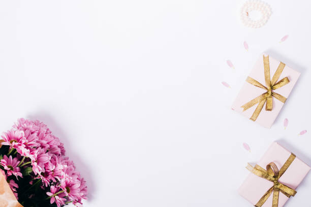 istock Top view of pink bouquet, petals, gift boxes 944319160