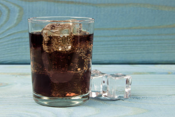 istock Sweet, fizzy drink with ice on a blue background. 944328716