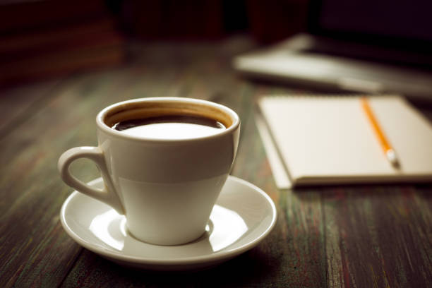 istock A cup of coffee in the workplace on a wooden table. 944328762