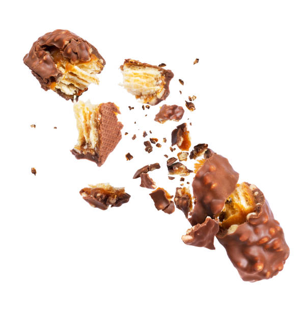istock Waffle chocolate bar with nuts broken into parts, isolated on white background 944329348