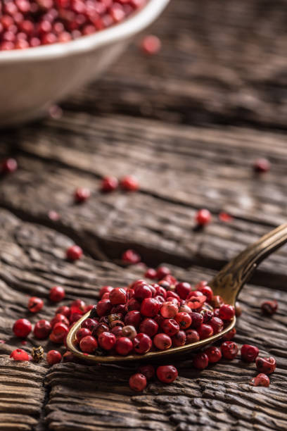istock Red peppercorn in bowl and spoon on oak table 944332828