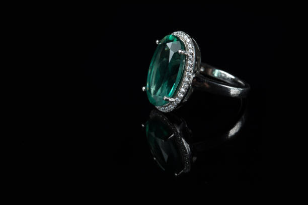 istock Silver ring with a green amethyst on a black background 944333604