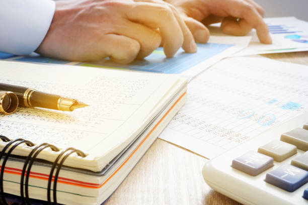 Manager working with business papers in the office. Financial audit.