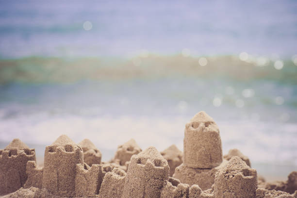 istock Sand castle standing on the beach. Travel vacations concept. 944334154
