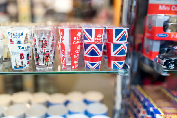 A London souvenir shop displaying English shot glasses with the union jack, keep calm and carry on and beefeater and London Tower Guards printed on them in the UK A London souvenir shop displaying English shot glasses with the union jack, keep calm and carry on and beefeater and London Tower Guards printed on them in the UK London Memorabilia stock pictures, royalty-free photos & images