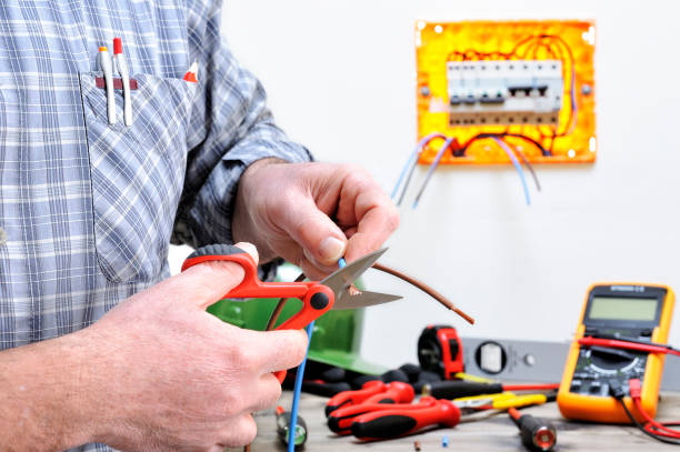 Electrician technician at work on a residential electric system Electrician technician at work in a residential electric installation, cuts the cable cable tester stock pictures, royalty-free photos & images