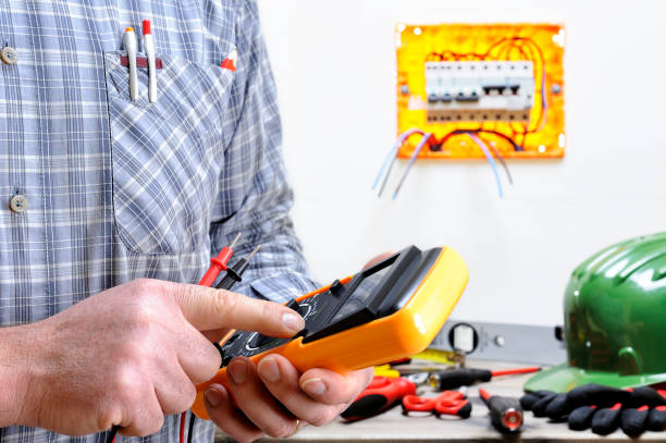Electrician technician at work on a residential electric system Electrician technician at work in a residential electric installation, turn on the tester cable tester stock pictures, royalty-free photos & images