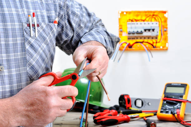 Electrician technician at work on a residential electric system Electrician technician at work in a residential electric installation, cuts the cable cable tester stock pictures, royalty-free photos & images