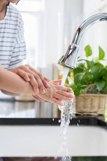 istock Unrecognizable mother shows child how to wash hands 944351550