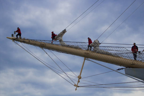 SCF Black Sea Tall Ships Regatta 2016, parade of sales at Varna   bay , four persons from the crew setting sails on bowsprit
