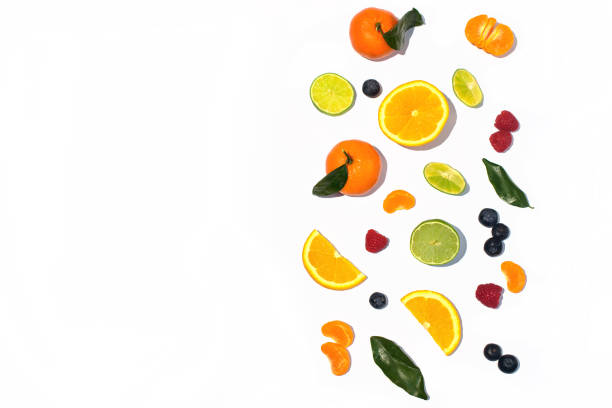 istock Colorful fresh fruit on white table background isolated. Orange, tangerine, lime, citrus, grapefruit. Fruit pattern. Summer food concept. Top view. 944352628