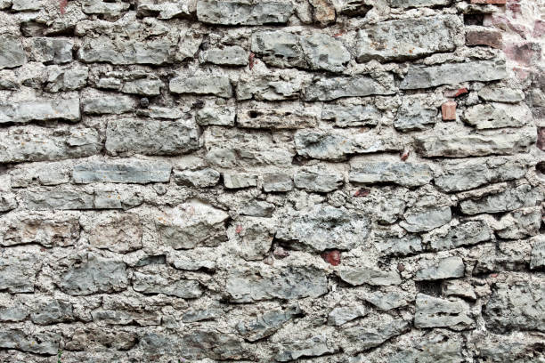 istock Wall of big stones and broken bricks 944355360