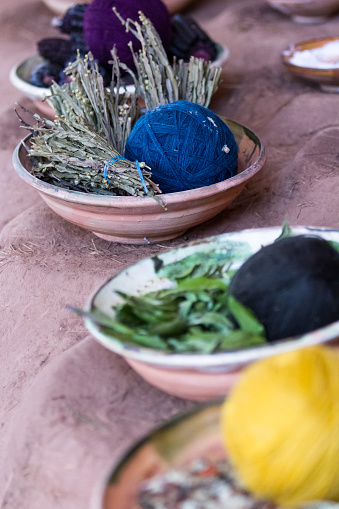 close up of a table with natural products used to dye clothing in traditional Peruvian styles and colors