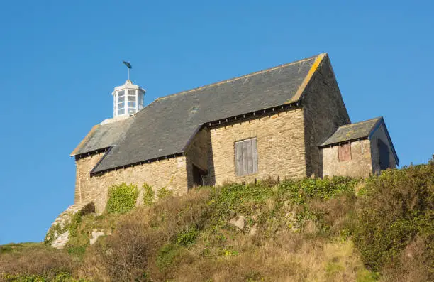 Old Coastguard building with lighthouse on headland at Ilfracombe, Devon, England