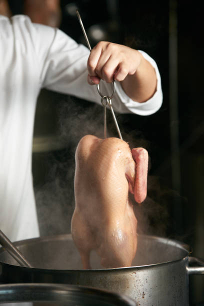 Chef preparing of Peking Roast Duck in the kitchen of restaurant. Peking Duck is a famous duck dish from Beijing