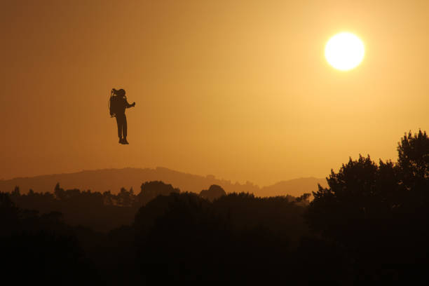 A series of retouched illustrated images of a silhouette of a rocket jetpack man flying in the sky at sunset. There are a range of positioning of the rocket man to suit your needs. Medium distance composition. The rocket man is an illustration put on a background image of the sunset. The rocket man illustration is an illustration that I drew in photoshop. You will see that it is just a flat shape with no tone or detail, but because it is a silhouette against the sky, it works well. The illustration is a traced illustration from a photographic origin and I took the original photo so I understand that I am the sole copyright holder. I have attached it for you to view in the releases upload as requested.
