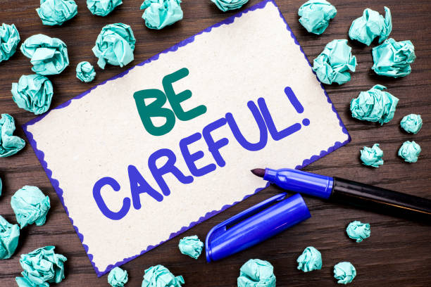 istock Writing note showing  Be Careful. Business photo showcasing Caution Warning Attention Notice Care Beware Safety Security written on Cardboard Piece on the wooden background Marker next to it. 944372412