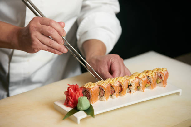 istock Chef prepares sushi with torch burner. 944372750