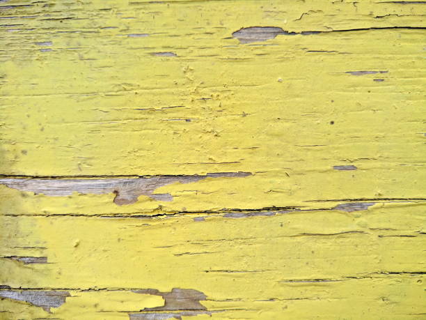 istock Wooden texture with cracked yellow paint, old pattern with shabby paint, cracked surface, abstract background for the designer, minimalism, blank for the designer, vintage style 944373552