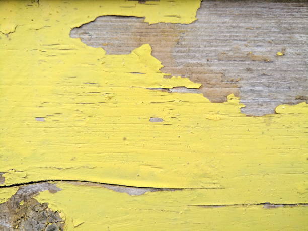 istock Wooden texture with cracked yellow paint, old pattern with shabby paint, cracked surface, abstract background for the designer, minimalism, blank for the designer, vintage style 944373570
