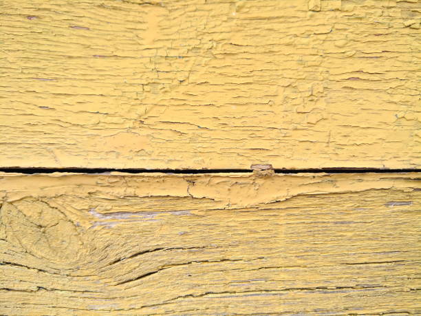 istock Wooden texture with cracked yellow paint, old pattern with shabby paint, cracked surface, abstract background for the designer, minimalism, blank for the designer, vintage style 944373680