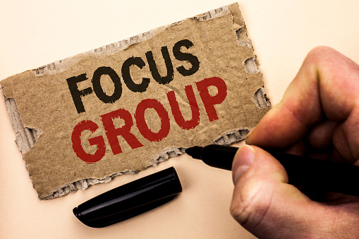 Writing note showing  Focus Group. Business photo showcasing Interactive Concentrating Planning Conference Survey Focused written by Man Holding Marker tear Cardboard Piece Plain Background.