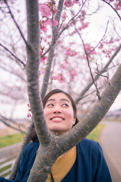 istock Happy young woman making funny face between branch 944377038