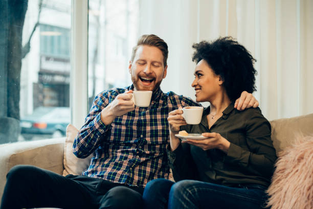 istock Couple smiling and drinking coffee in coffee shop 944380146
