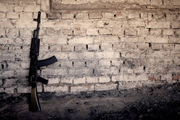 istock submachine gun kalashnikov AK-47 against the wall 944385452