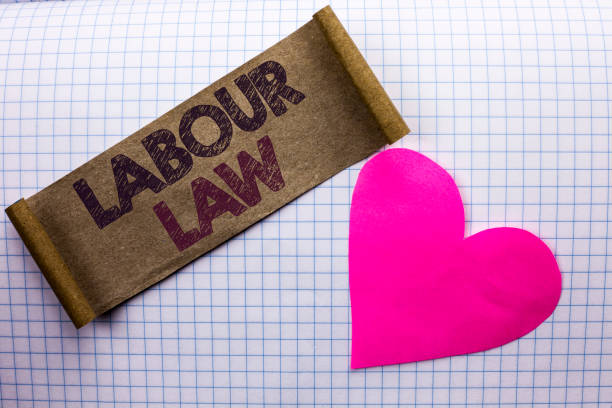 istock Handwriting text Labour Law. Concept meaning Employment Rules Worker Rights Obligations Legislation Union written on Cardboard Piece on the check background Heart next to it. 944385686