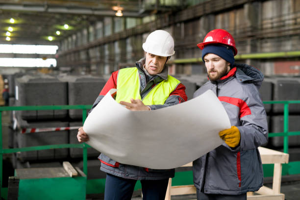 istock Workers Discussing Schemes at Factory 944389310