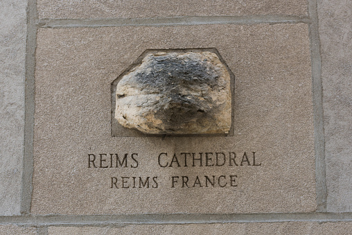 Chicago, USA – Mar, 15 2018: Late in the day A piece of the Reims Cathedral embedded in the wall of the Historic Tribune Tower on Michigan avenue. The Tribune Tower has 150 stones handpicked and brought from around the world and embedded in the Limestone wall.
