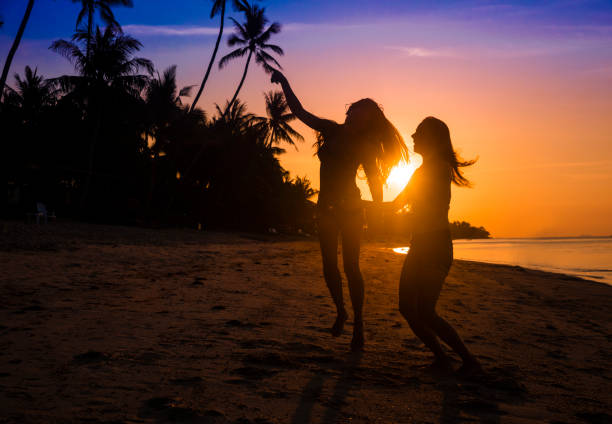 istock friends dancing on a sunset beach 944398694