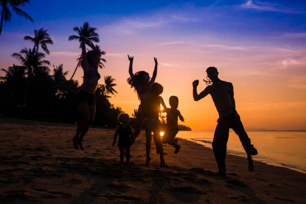 istock friends dancing on a sunset beach 944398696