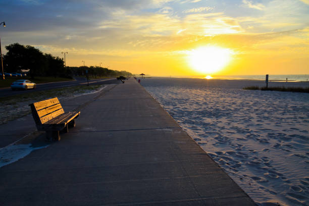 Beautiful rich panorama of the sea landscape in the rays of the setting sun over the horizon. Calm sea at sunset