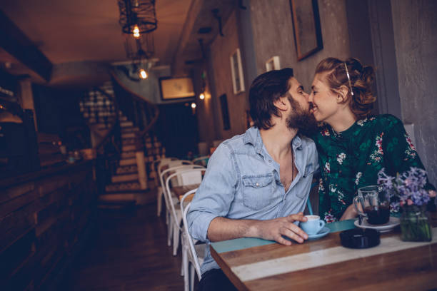 istock Couple kissing in coffee shop 944407152