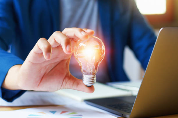 istock businessman holding lightbulb in office. creative idea for saving energy. concept finance and accounting 944409586