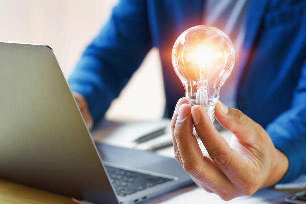 istock businessman holding lightbulb in office. creative idea for saving energy. concept finance and accounting 944409590