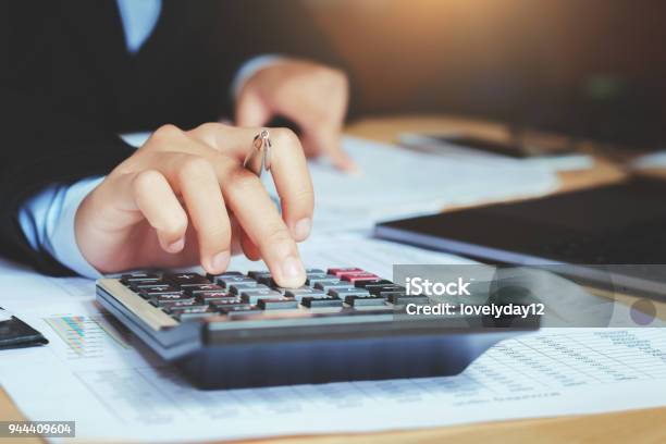 Close Up Hand Accountant Using Calculator With Laptop Concept Saving Finance And Accounting Stock Photo - Download Image Now