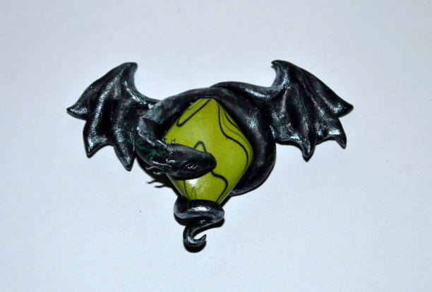 Dark silver dragon on a green stone orb