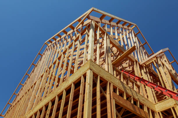 istock New residential construction house framing against a blue sky. 944419438