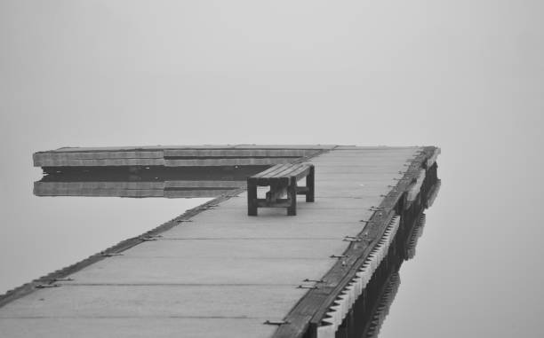 istock Empty Bench Wooden Pier in the Fog 944422500