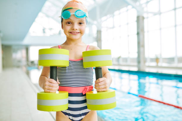 istock Ecstatic girl with aerobics dumbbells 944424998
