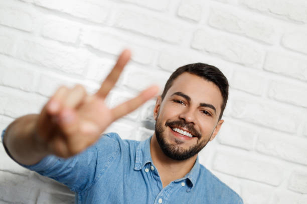 istock Facial Expressions Of Young Beard Man On Brick Wall 944425470