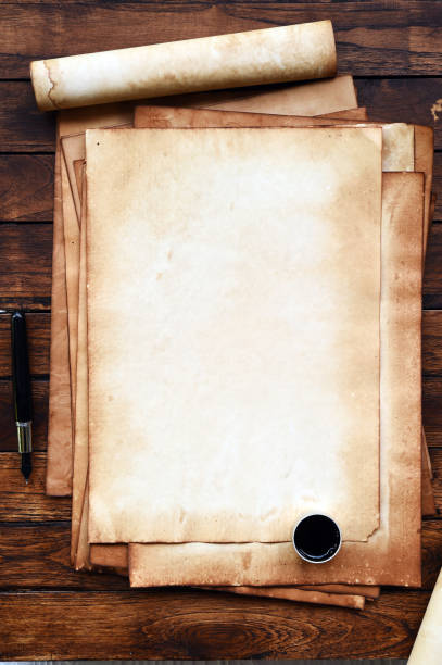 istock old paper on brown wood texture with pen and ink 944428378