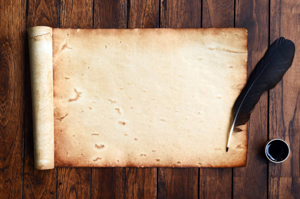 istock old paper on brown wood texture with feather and ink 944428382