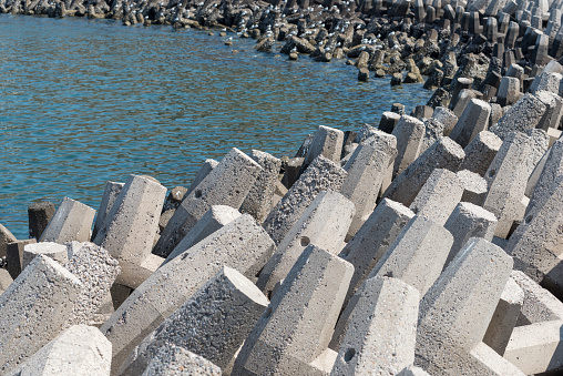 Concrete pre-formed coastal defences known as tetrapods which reduce the effects of the waves (rather than abruptly stopping them) and therefore preventing coastal erosion